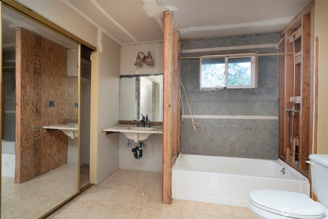 full bath featuring washtub / shower combination, toilet, and tile patterned floors