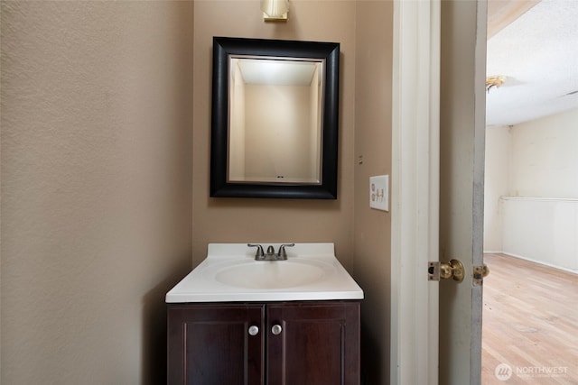 bathroom featuring vanity and wood finished floors