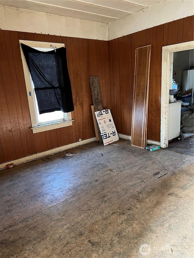 empty room featuring wooden walls