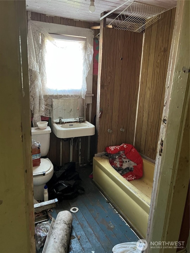 bathroom with toilet, hardwood / wood-style flooring, and a sink