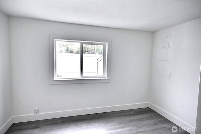 empty room with wood finished floors and baseboards