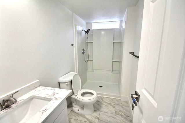 bathroom with marble finish floor, vanity, walk in shower, and toilet