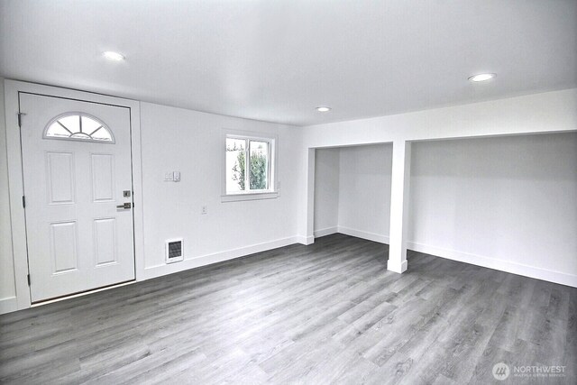 entrance foyer featuring wood finished floors, visible vents, and baseboards