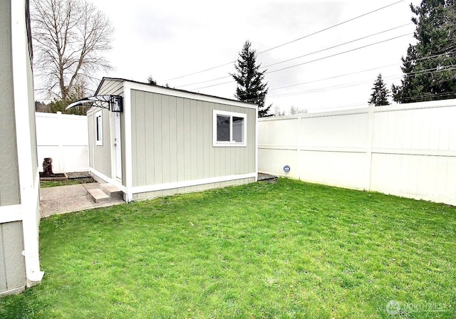 view of yard featuring an outbuilding and a fenced backyard