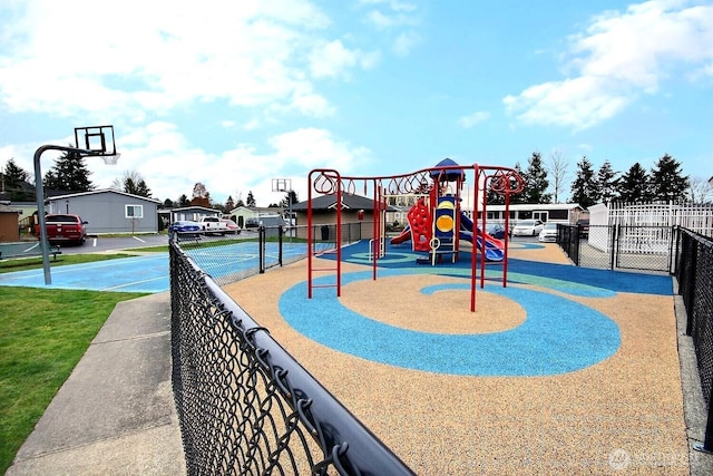 community play area with a residential view and fence