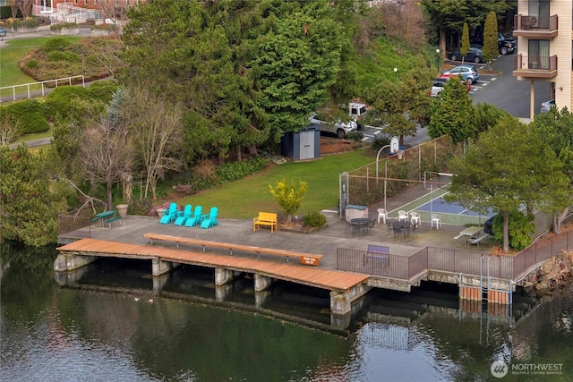 dock area featuring a water view and a lawn