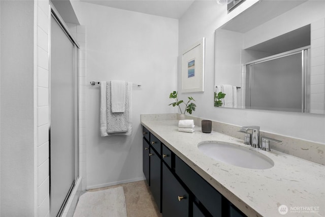 full bathroom with a stall shower and vanity