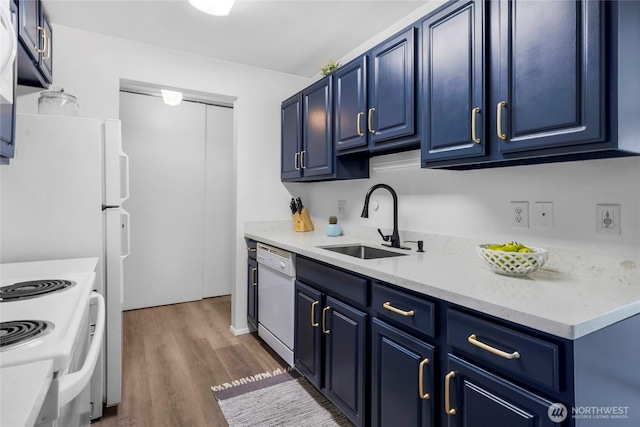 kitchen featuring blue cabinets, dishwasher, light countertops, and a sink