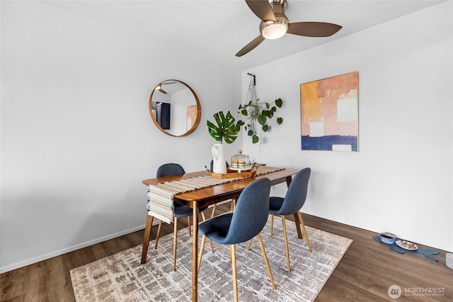 dining space with baseboards, ceiling fan, and wood finished floors