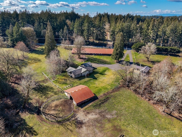 drone / aerial view with a wooded view