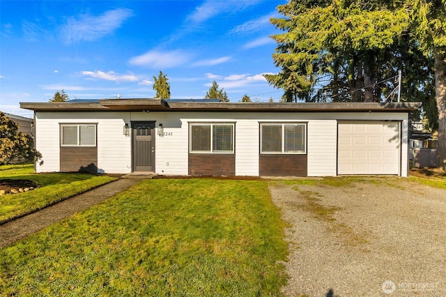 single story home featuring a garage, driveway, and a front yard