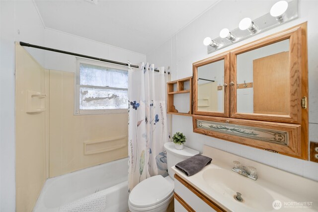 bathroom with vanity, shower / bath combination with curtain, and toilet