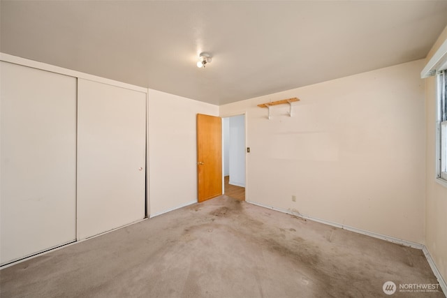 unfurnished bedroom with carpet floors and a closet