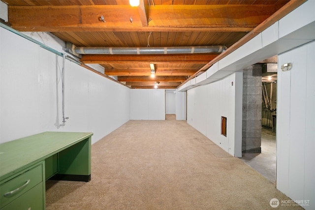 unfinished below grade area featuring carpet floors and wooden ceiling