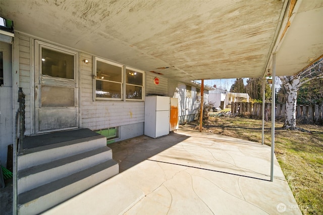 view of patio featuring entry steps and fence