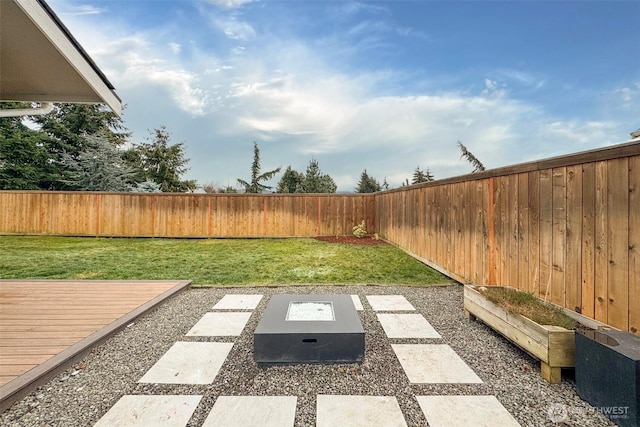 view of yard with a fenced backyard and a deck