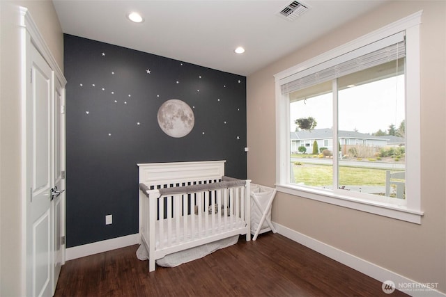 bedroom with visible vents, baseboards, wood finished floors, and recessed lighting