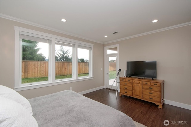 bedroom featuring dark wood-style floors, ornamental molding, and baseboards