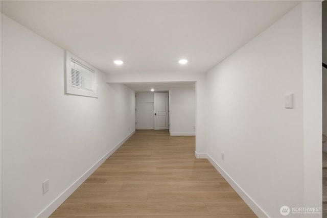 hallway featuring recessed lighting, light wood-style flooring, and baseboards