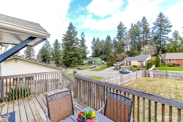 deck with fence private yard, a residential view, and a lawn