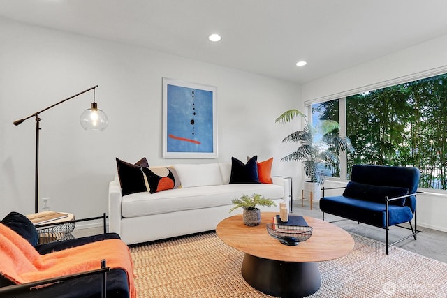 living room featuring a healthy amount of sunlight, baseboards, and recessed lighting