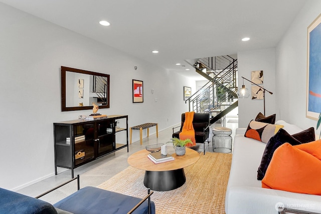 living room featuring recessed lighting, concrete floors, stairway, and baseboards