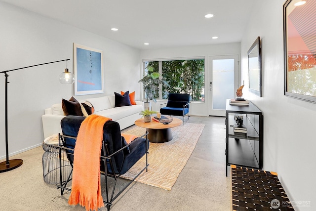 living room featuring baseboards and recessed lighting