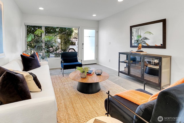 carpeted living area featuring baseboards and recessed lighting