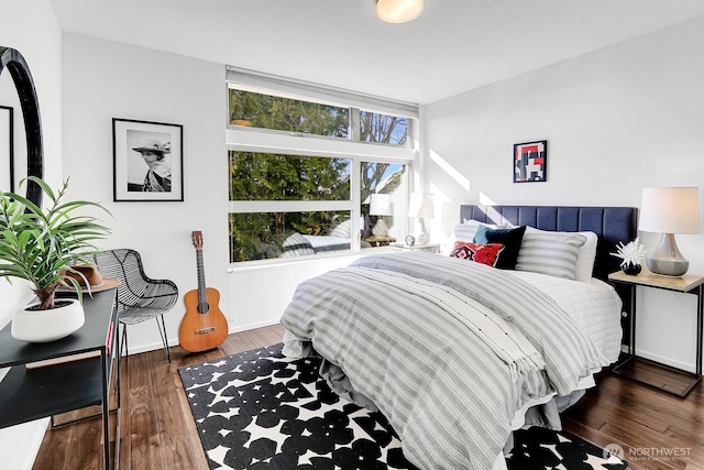 bedroom featuring baseboards and wood finished floors