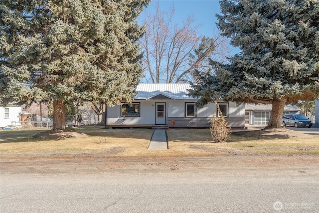 ranch-style house with a front lawn and metal roof