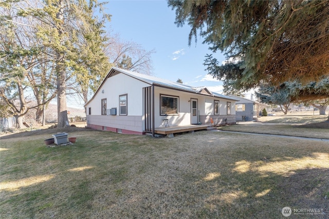 view of front of house featuring a front lawn and a wooden deck