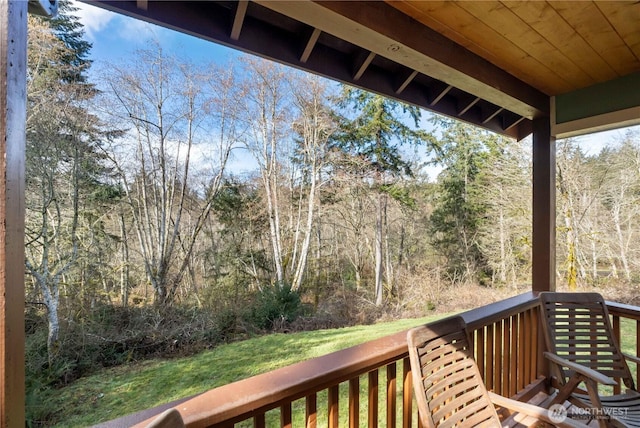 wooden deck featuring a yard