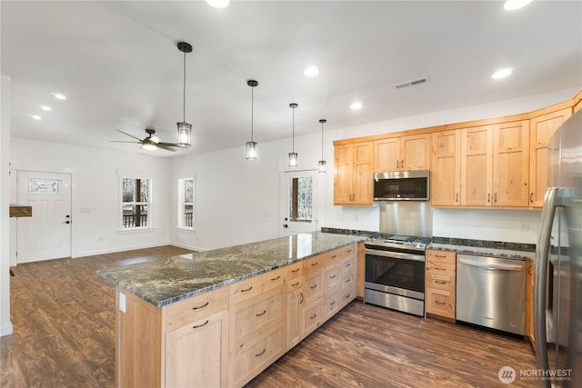 kitchen featuring stainless steel appliances, visible vents, a peninsula, and light brown cabinetry