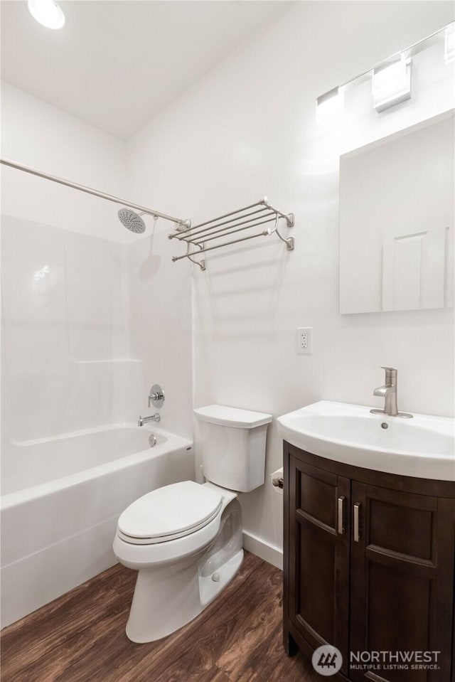 full bathroom with  shower combination, vanity, toilet, and wood finished floors