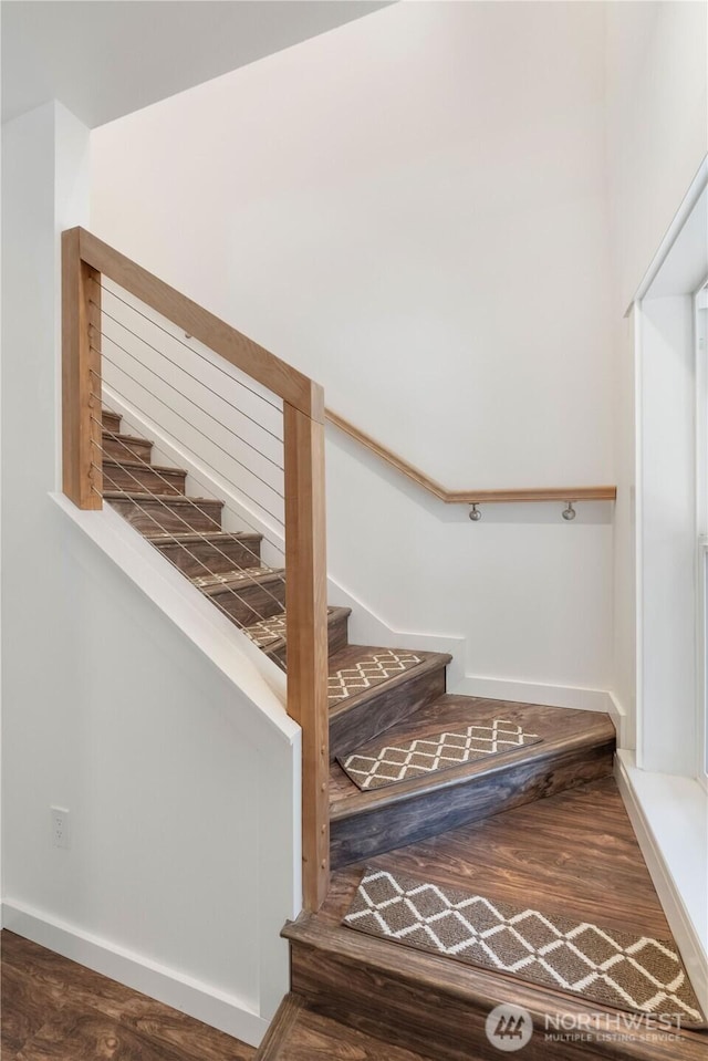 stairway featuring wood finished floors