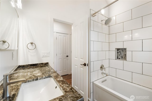 bathroom featuring tub / shower combination and vanity