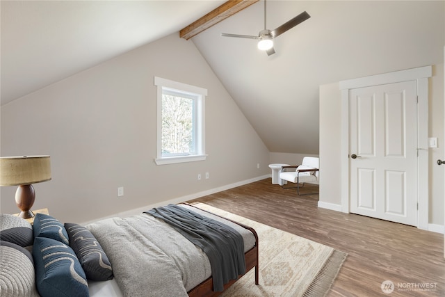 bedroom featuring a ceiling fan, lofted ceiling with beams, baseboards, and wood finished floors