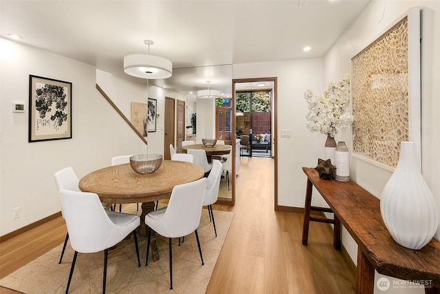 dining area featuring recessed lighting, light wood-style flooring, and baseboards