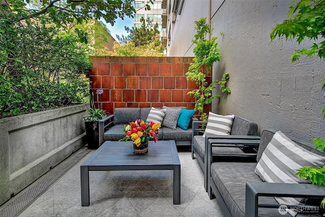 view of patio / terrace featuring outdoor lounge area and fence