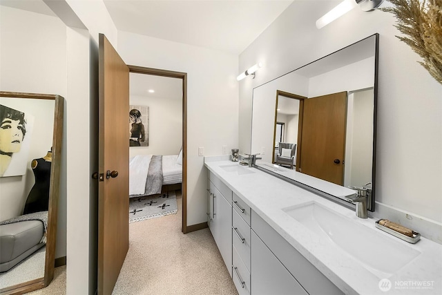 bathroom featuring a sink, double vanity, and ensuite bath