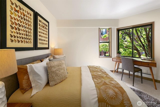 carpeted bedroom featuring baseboards