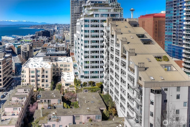 view of building exterior with a view of city and a water and mountain view