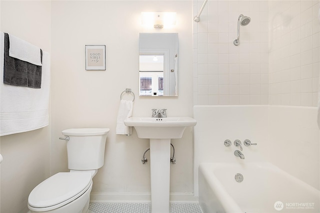 full bath featuring toilet, tile patterned flooring, baseboards, and bathing tub / shower combination