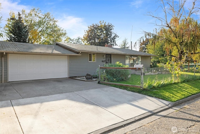 ranch-style home with a garage, driveway, and fence