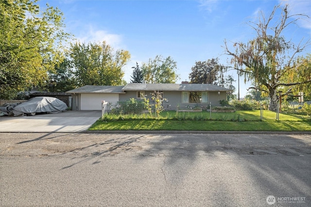 single story home featuring concrete driveway, a front lawn, a fenced front yard, and an attached garage