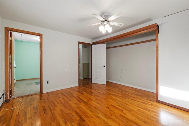 unfurnished bedroom with wood finished floors, a ceiling fan, and baseboards