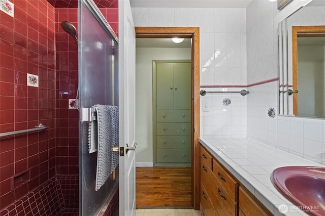 full bath featuring tasteful backsplash, a shower stall, and vanity