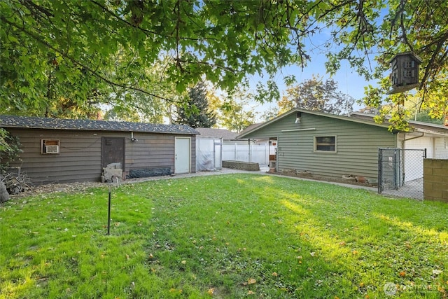 view of yard with an outbuilding and fence