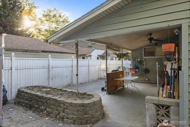 view of patio / terrace with ceiling fan and fence