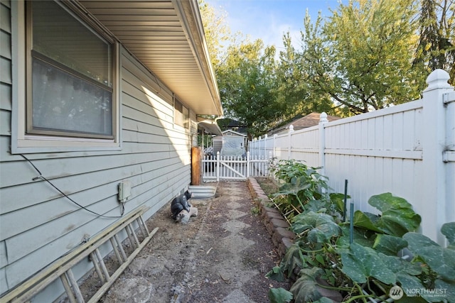 view of home's exterior with a gate and fence